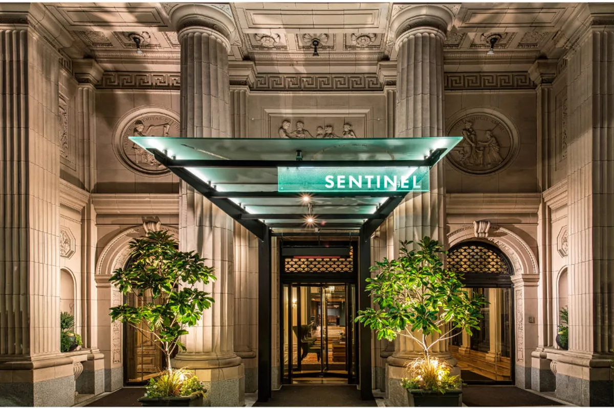 This image showcases the SENTINEL entrance sign above ornate columns, decorative architectural details, and lush potted plants. The sophisticated facade sets the stage for a luxurious welcome, inviting guests into an upscale environment that reflects the spirit of Portland’s West End.