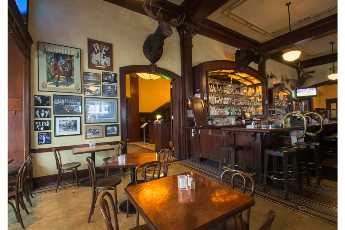 Inside, a stylish lounge features a well-appointed bar, striking wall art, and comfortable tables. The room is lively yet relaxed, ideal for networking, socializing, or unwinding after a productive day.